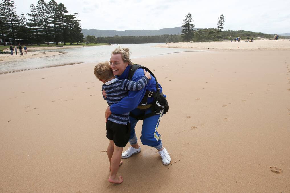 Senior Constable Hayley Hopson hugging her son after completing the Great Cop Drop at North Wollongong on Sunday. Picture: Adam McLean