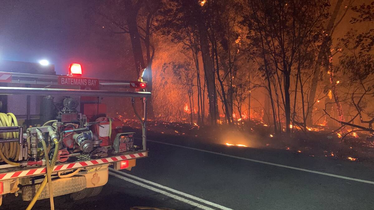 Fire crews battle a bushfire that is threatening homes near Batemans Bay. Picture: Picture: Ben Schutz, Batemans Bay RFS Brigade