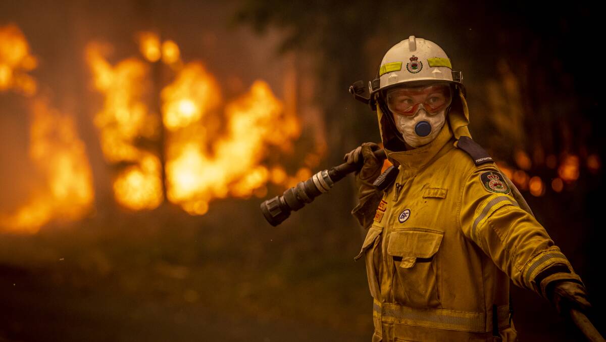 Milton Rural Fire Brigade volunteer Stacey Wilson at the bushfire front on Murramarang Road in Bawley Point on December 5. Picture: Sitthixay Ditthavong