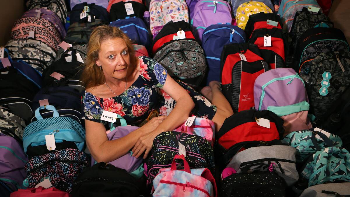 FUNDRAISER: Leanne Shackell with the 165 backpacks she has collected to donate to school kids in fire-affected areas. Picture: Sylvia Liber.