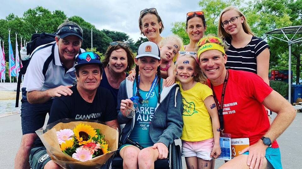SMILES ALL ROUND: Lauren Parker (centre) with her support team after claiming her maiden world title in Switzerland. Picture: Twitter via @medaverobbo
