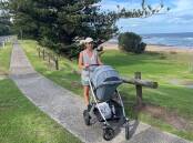 Erin Harvey with her baby son at Little Austinmer beach on the path set to be widened. Picture Ben Langford.