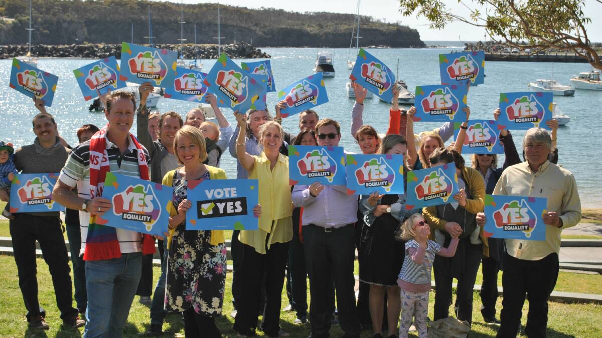 PROUD: Roger Nee and Emily Jenkins stand in front of a group of Milton-Ulladulla businesses who have united to publicly support the "yes" vote. Photo: Jessica McInerney.