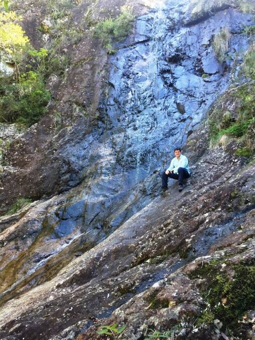 Hidden in the wilderness: Batemans Bay bushwalker Simon May resting at the rocky base of “No Name Waterfall".