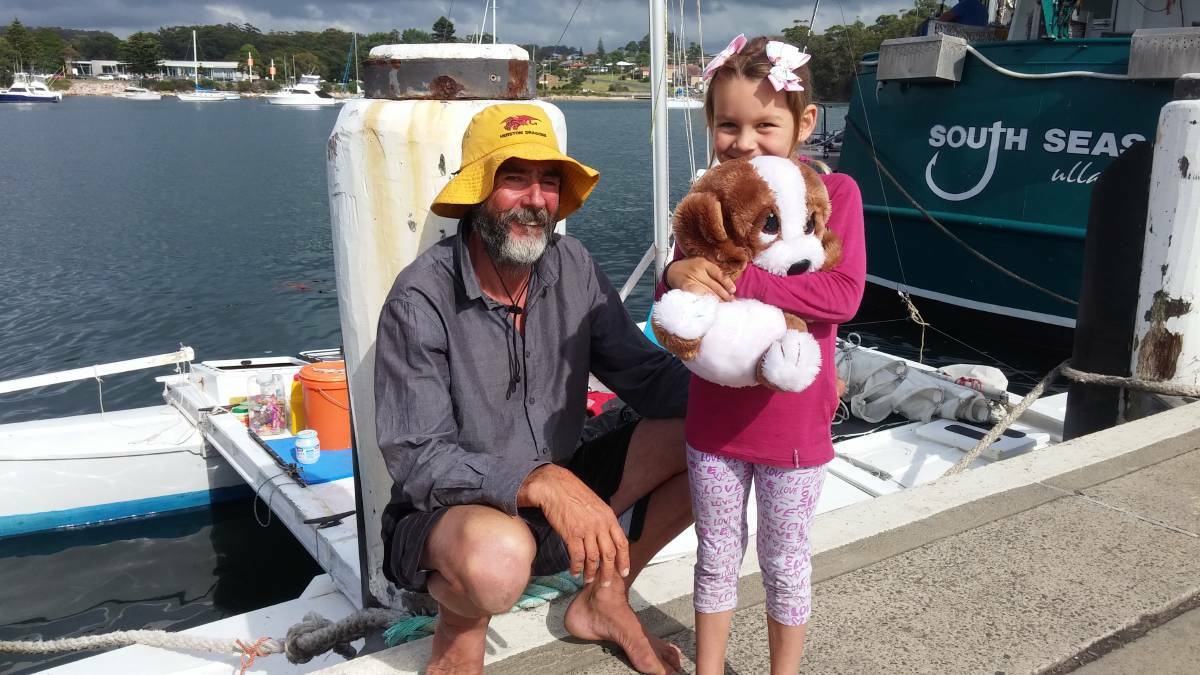 Alan, Que and ‘Dog’ Langdon at Ulladulla Harbour with the catamaran in which they traveled for 27 days across the Tasman Sea behind them.