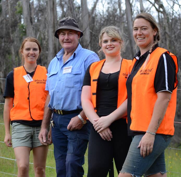 HANDS ON: Lauren Campbell, of Ireland, (right) and her Blaze Aid crew re-fenced the Stewart's Nerrigundah property before packing up for the year. 