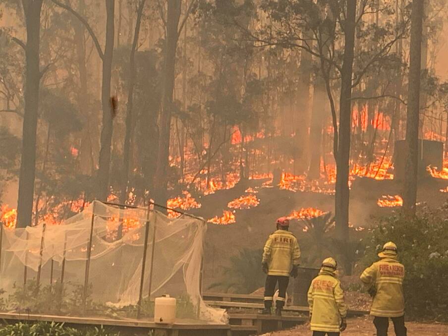 BATTLE: Batemans Bay Fire and Rescue crews returned to protect their district to continue the fight after battling flames between Batemans Bay and Broulee on New Year's Eve morning.