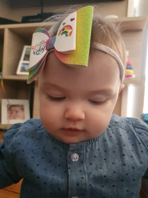 Amarli sporting her 'rainbow baby' headband. The eight-month-old has brought so much happiness to her parents' lives. Photo: supplied. 