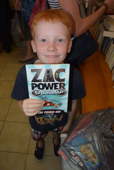 POWER BOOK: Connor Minchin picks up a winner at last year's book sale. 