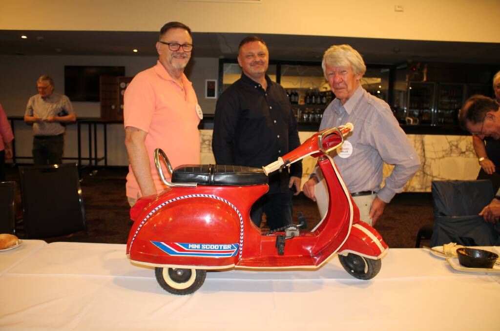Mark Wilson, Jason Cox and Richard Miller with the beautiful restored scooter. Photo supplied. 
