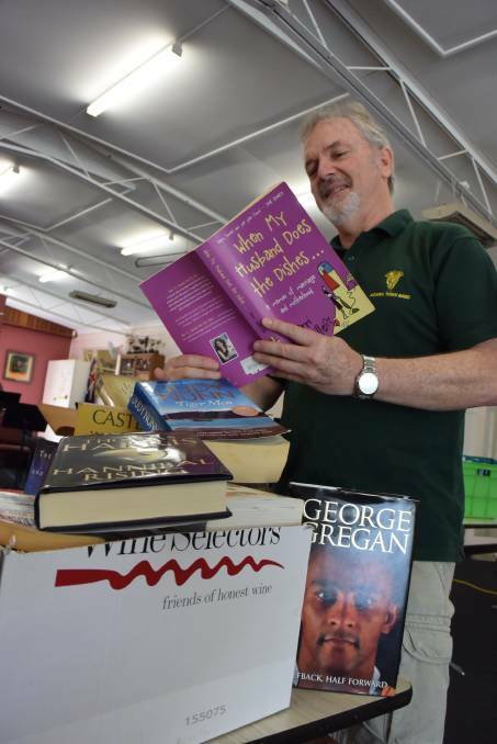 PACKED SHELVES: Nowra Town Band member and sale coordinator Murray Ford is gearing up for a big weekend. 

