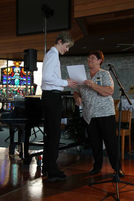 Luke Bowen receives his award from Annette Chapman, president of Moruya CWA. Photo: contributed. 