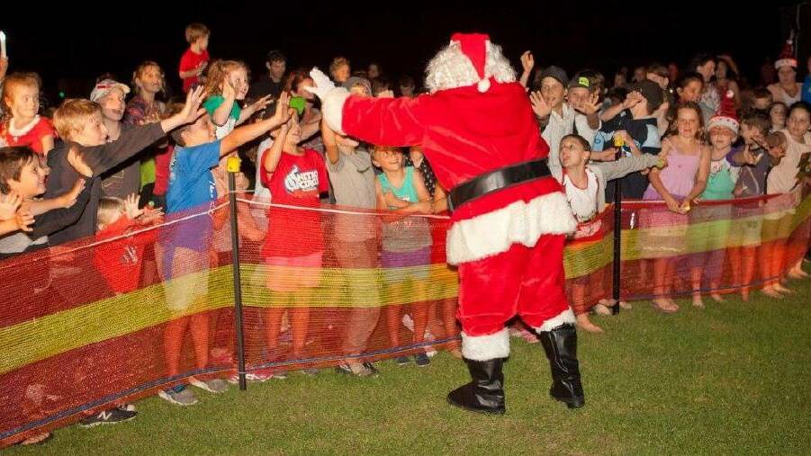 FESTIVITIES: Santa flew in to the Callala carols last year and he'll be sure to fly in again this year. Photo: davemaccphotos.com