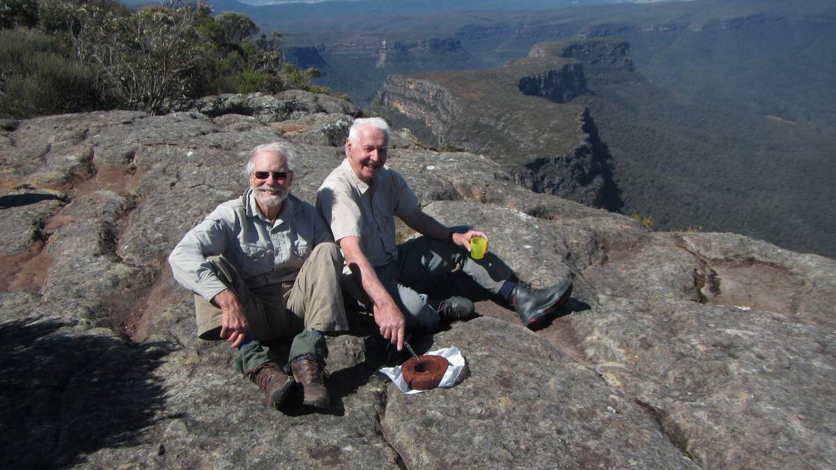 AIMING HIGH: Albert Forgan and John Kubale enjoy well-earned cake. They also received the Shoalhaven Bushwalkers most prestigious honour - the Over Bloody Eighty badge. 
