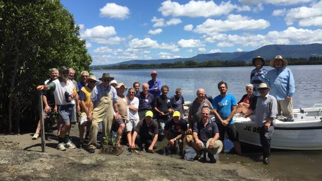 HARD WORK: Shoalhaven Riverwatch members take a quick break after recently planting 470 mangroves.  
