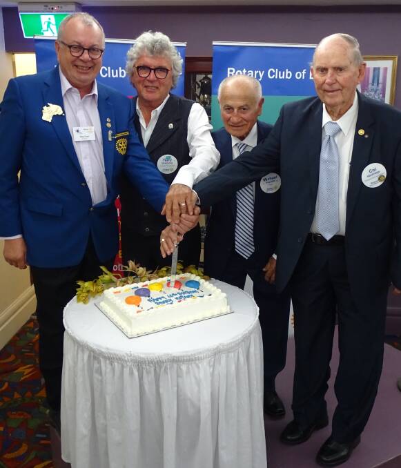 Col Hanbridge (far right) cutting the anniversary cake, along with District Governor Peter Ford, Berry Club president Terry Delahunty, and second longest serving member Mick Vassallo. Photo: supplied. 