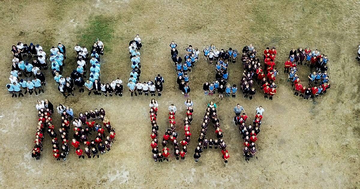 TAKE A STANCE: Nowra Christian School participate in National Day of Action against Violence and Bullying. Students and staff gathered for an aerial shot, adding two exclamation marks to accommodate everyone (out of shot) 