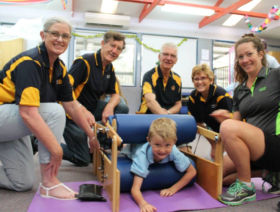 SENSORY EXPERIENCE: Havenlee student, Mitchell Mussig, enjoying being ‘put through the ringer’ by Nowra Rotarians (from left to right) Jacquie Cousley, Phil Presgrave, Graeme Cord, Polly Hill and teacher, Kiah Johnston. Photo: contributed. 