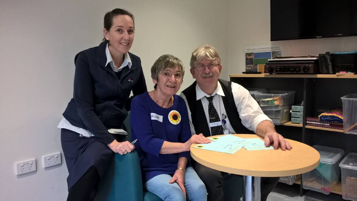 JOIN IN: Nurse unit manager Nicole Ledger, volunteer Ellen Burton, and Steve Swan, aged care clinical nurse consultant discuss plans for patient activities. Image: supplied. 