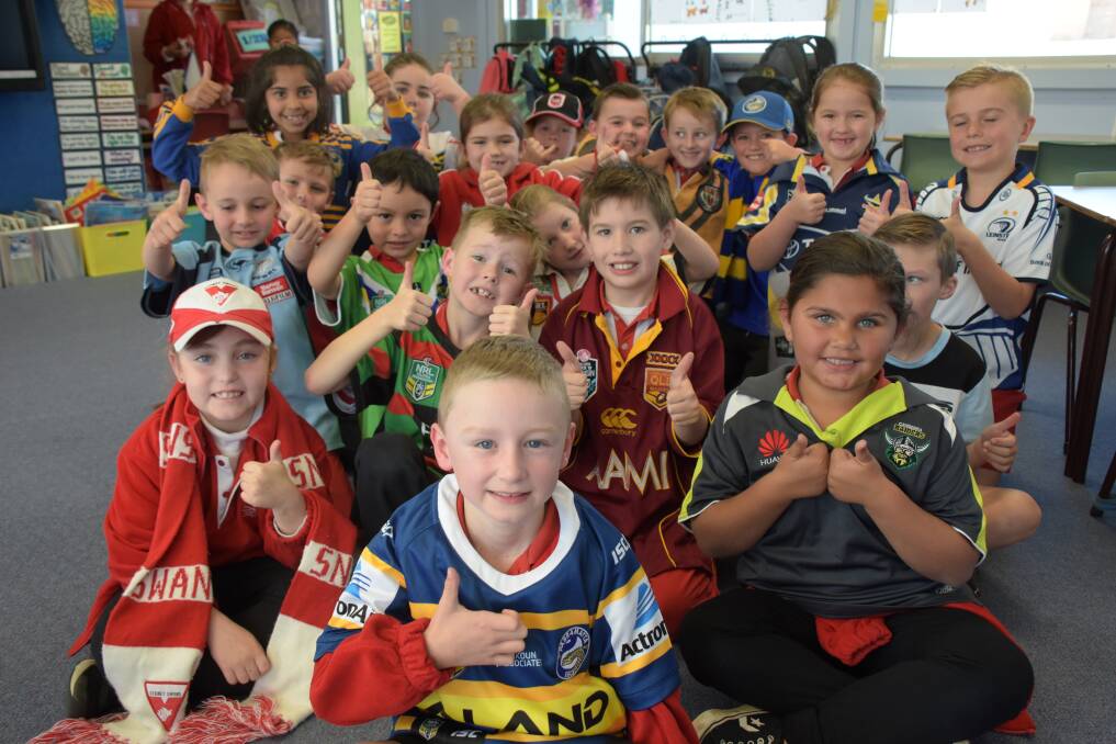 GAME FACE: Year two student Jett Waldron (centre) and his classmates will sport their favourite team's jerseys again next month to support Footy Colours Day. The event helps fund education programs, such as the one that helped Jett during his cancer treatment. 