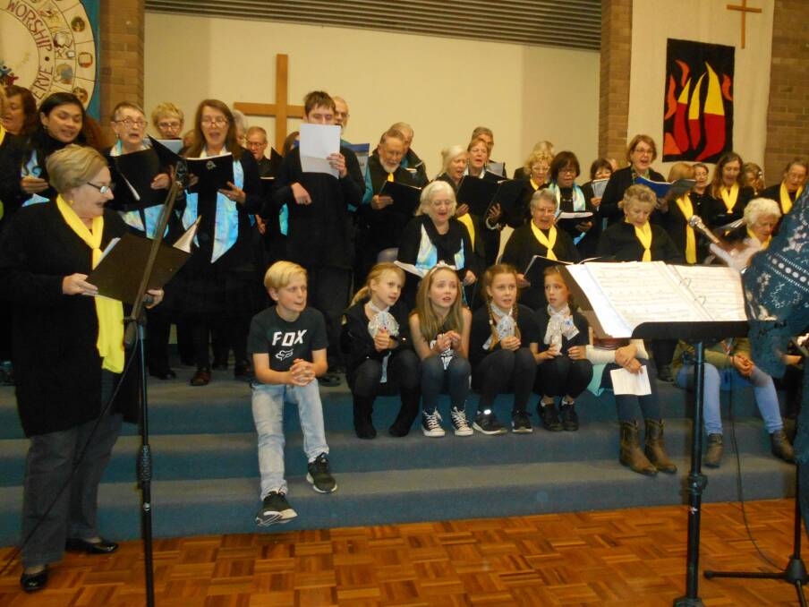 Combined choirs and performers on stage leading the audience in ABBAs Thank you for the Music. Photo supplied. 