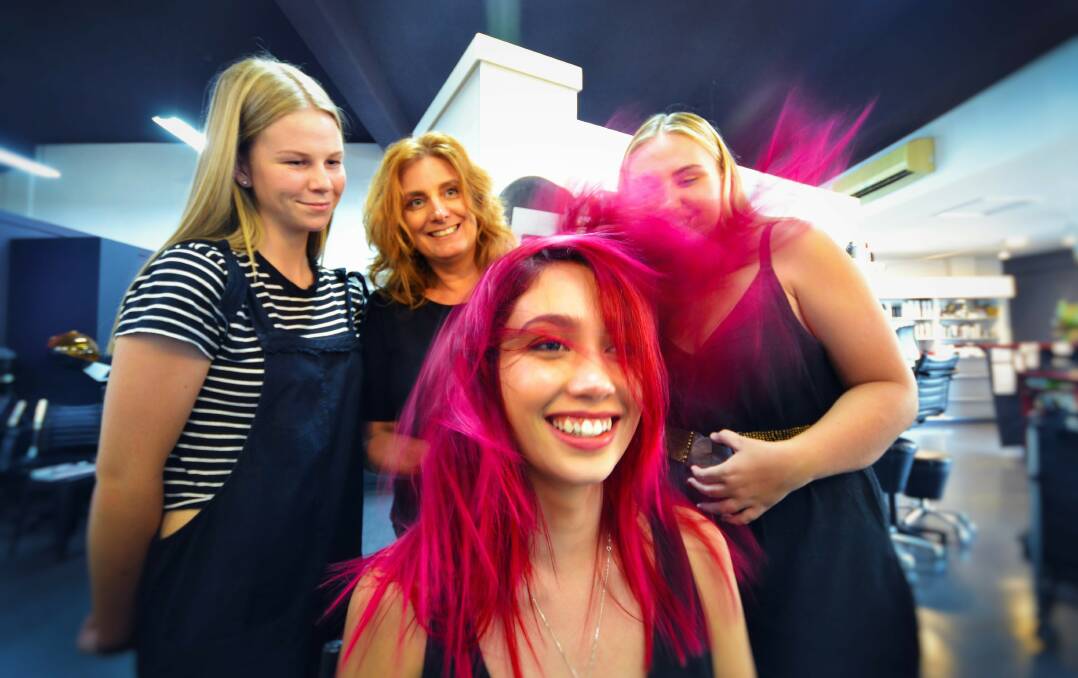 NEW LOOK: Scruples Hair and Beauty staff member Rylee Woods, owner Sandra Bayer and Emily Freu give Selina Elmer a style to brighten her day. Photo: TAFE NSW.