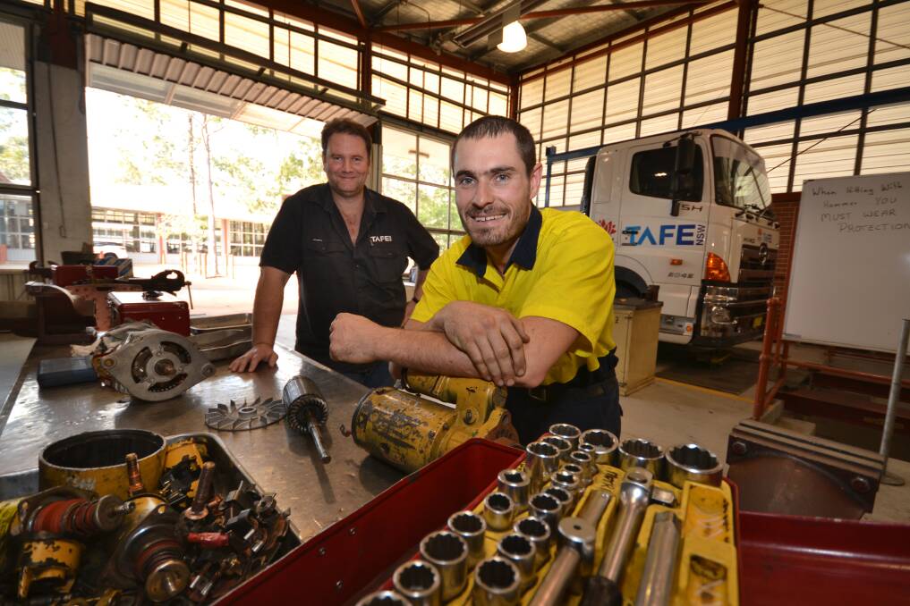 STUDYING: Heavy vehicle apprentice mechanic Nick Martin with automotive teacher Alex Copeland at the TAFE NSW Shellharbour training workshop. Pictures: Supplied