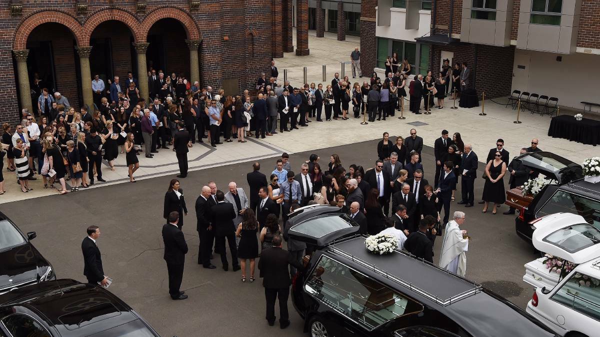 The crowd gathers outside the church after the funeral of Annabelle Falkholt and her parents Lars and Vivian Falkholt. 
