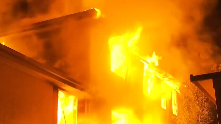 The Greta Street property engulfed in flames on Thursday night. Photos: Nine News