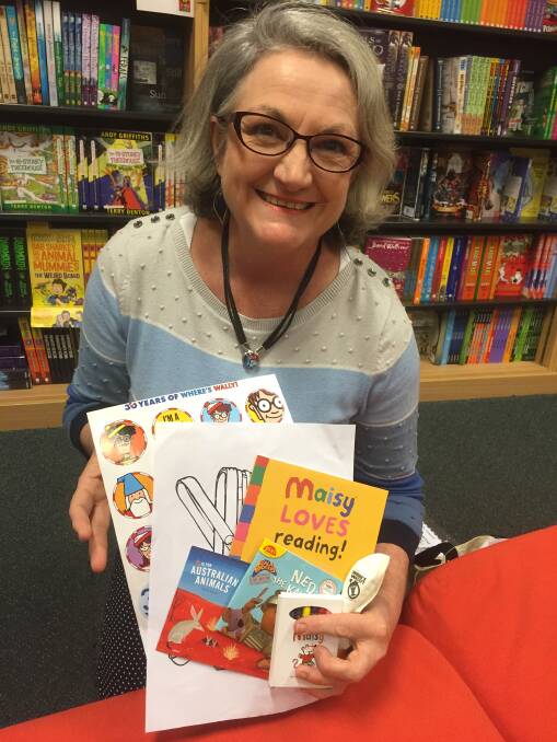 Gail Comber with the free book packs that will be given away during the Little Big Read event at the JellyBean Park Markets on July 28.