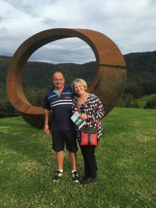 ORBIT VIEW: Just two of the many people who visited Sculpture in the Valley on the weekend, Michael Talbot and Lisa Clark in front of the winning outdoor sculpture by David Ball, 'Orb'. 