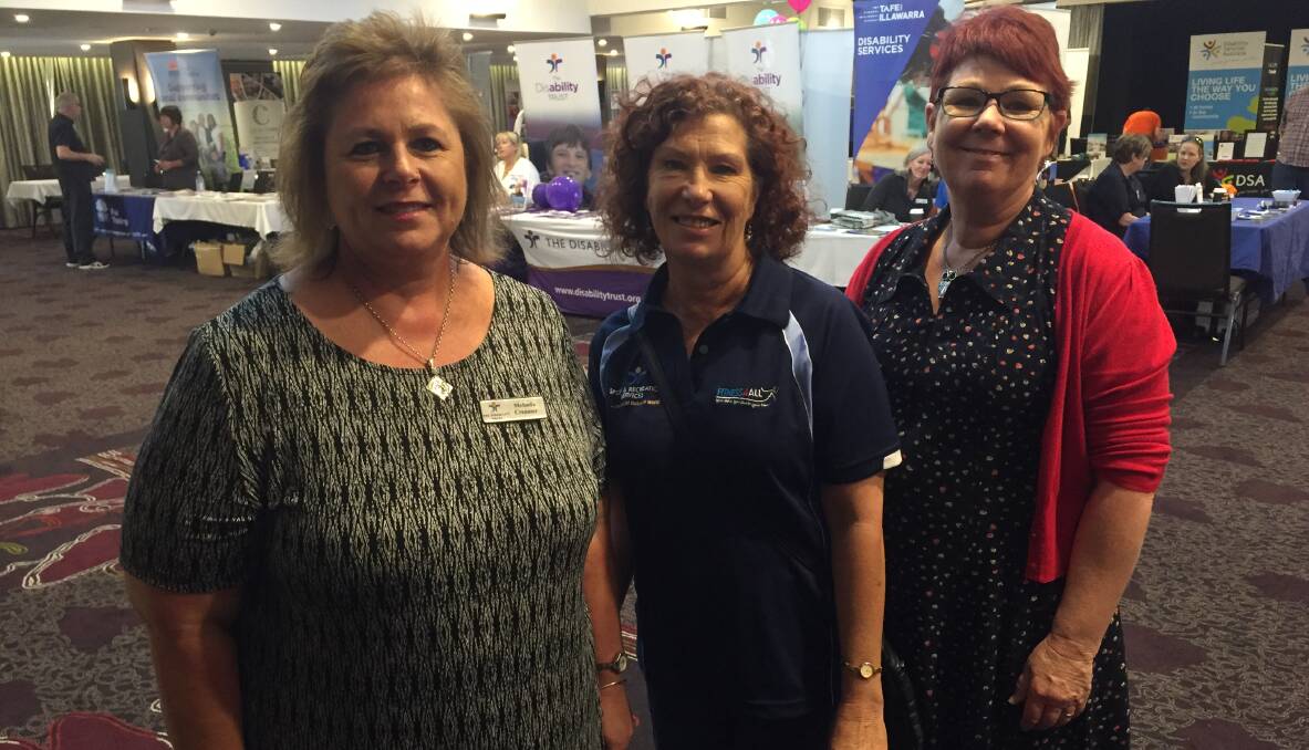 Melinda Creamer and Susan Booth from the Disability Trust with Jane Crowe from the Illawarra forum prepare for the expo.
