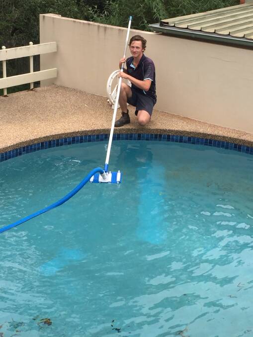 The dust has been a "daily" problem for pool owners. Jack Boxsell makes inroads on John Jacob's pool in North Nowra.