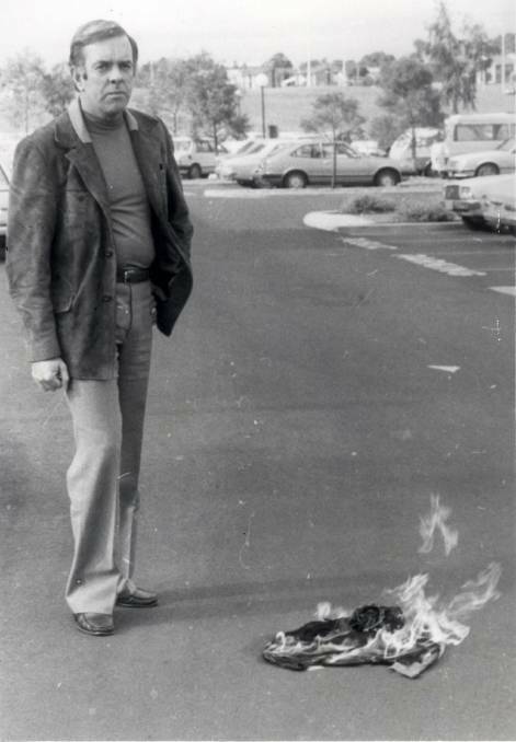 Cr Watson burns a hand-made Aboriginal flag in Nowra, in 1982. He has since apologised.