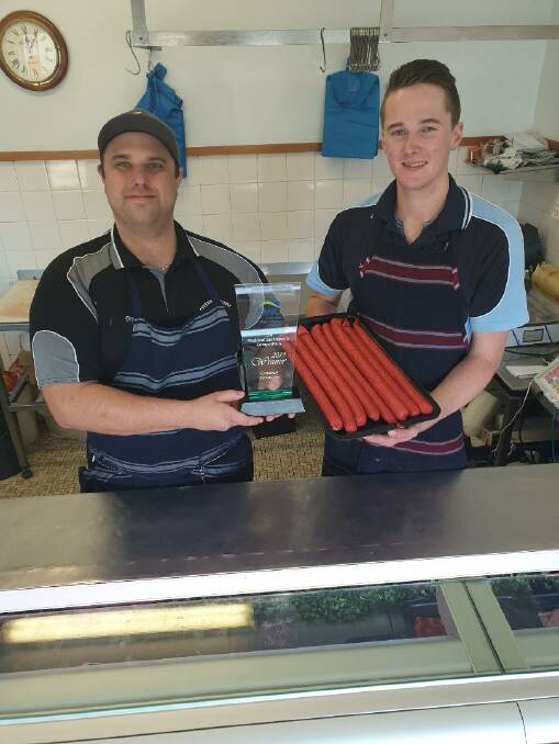 Butcher Bryce Warnock with employee Isaac Allen and some of their award-winning fare.