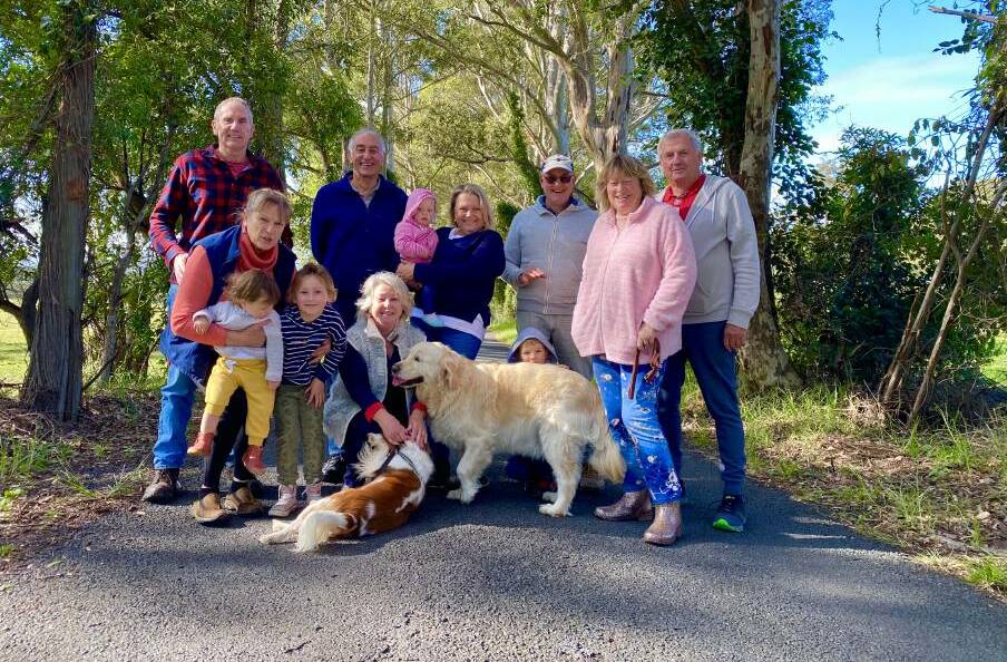Taylors Lane residents Bob Penfold, Maggie Penfold, Hannah George, Mida Gray, Russel Field, Marie Field, Zoe Penfold, Karyn Natoli, Ewan George, Steve Hazelton, Gayle Enright and Tony Enright with dogs Summer and Daisy want the tree tunnel to stay.