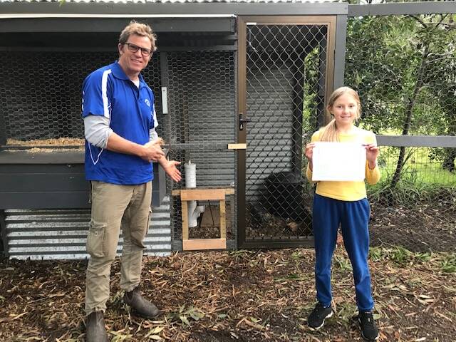 Alasdair Stratton presents Rosie Pollock with a certificate of appreciation for her fox-hunting efforts.