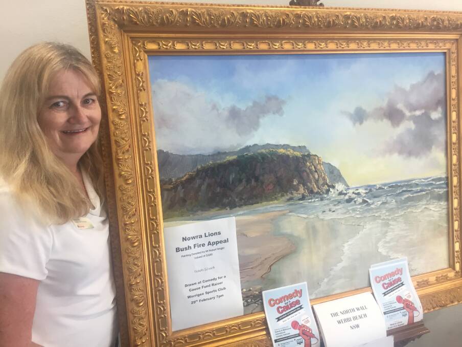 GET IN QUICK: Sharanne Whitt with the painting donated by local artist Robert Wright for the Nowra Lions bushfire fundraiser. Raffle tickets are available at St George Bank.