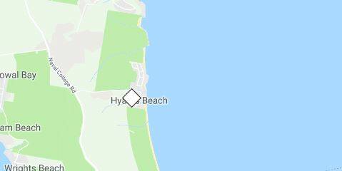 Emergency services are at Hyams Beach, where it has been reported a car with a single occupant is suspended over a cliff.