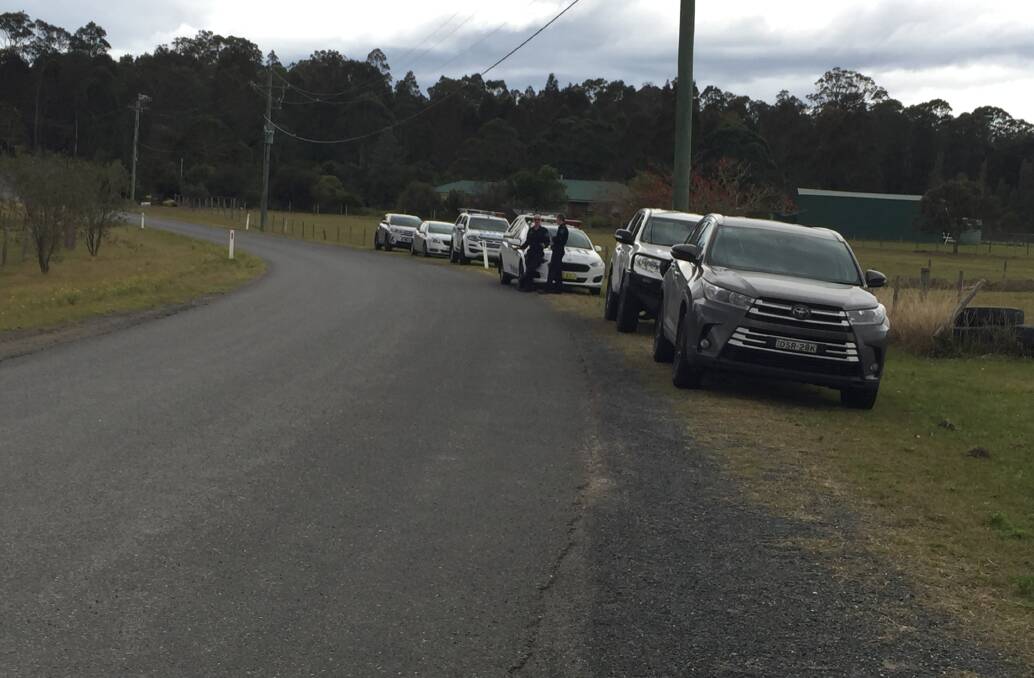 RAIDS: Police vehicles on Stringybark Drive, West Nowra, where a State Crime Command raid was conducted on Tuesday, August 25. Photo: Robert Crawford.