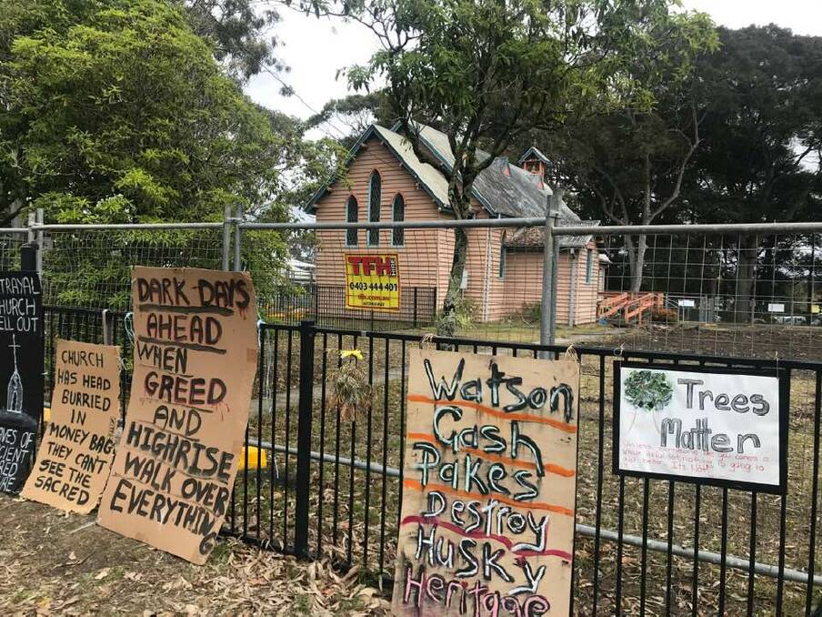 UNPOPULAR: Signs at the Huskisson Church site express the views of protestors about the development.