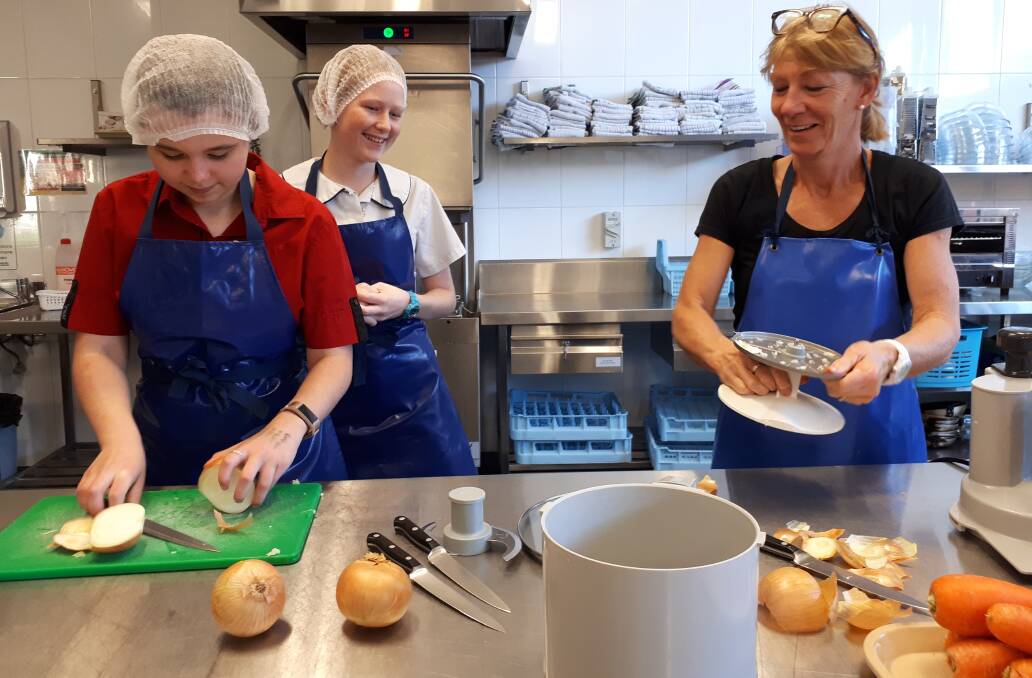HELPING HAND: St John's students and staff enjoy preparing hot, fresh meals for the St Vincent de Paul food van.