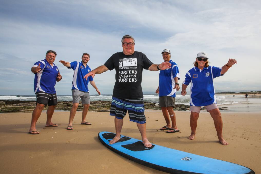 COWABUNGA: Volunteers Ian and Blake Picton, George Gribble and Fay Gribble with surfer Geoffrey Madden, who can't wait to get in the water on Sunday, March 27. Picture: Wesley Lonergan