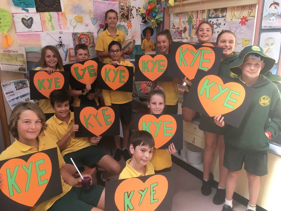 Kye's classmates wear their hearts on their signs.