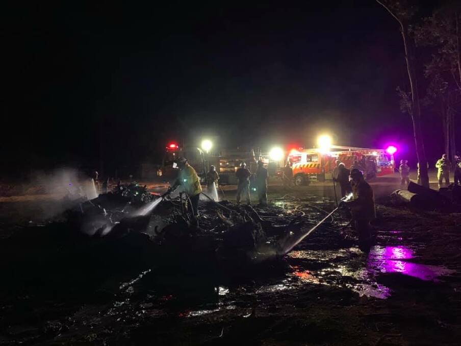Crews work to extinguish a fire caused by an escaped pile burn at Bangalee last night. Image credit: West Nowra RFS.