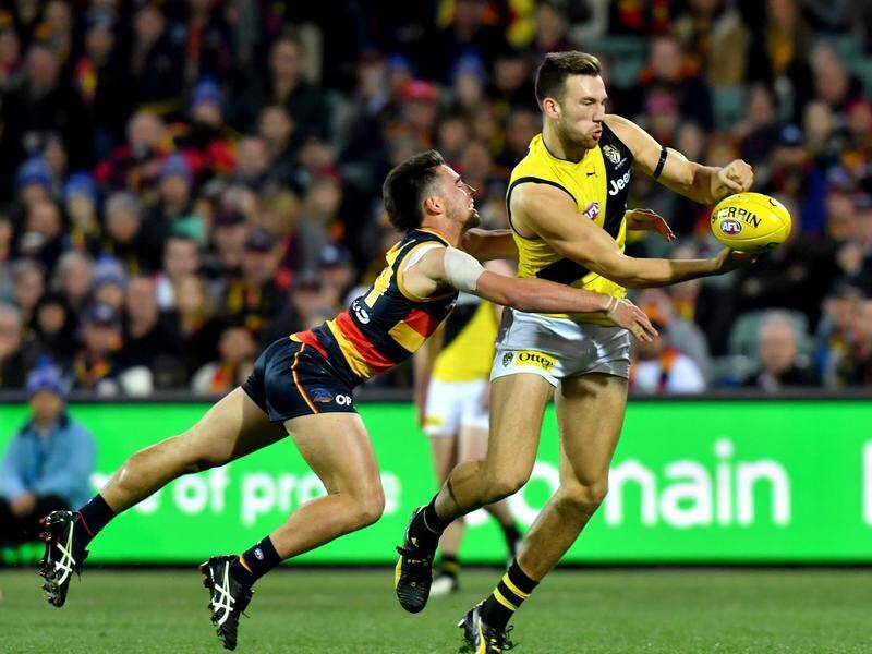 Noah Balta has been recalled to the Richmond team for the Tigers' AFL clash with Brisbane.