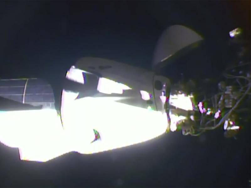 The SpaceX Dragon crew capsule has docked with the International Space Station.