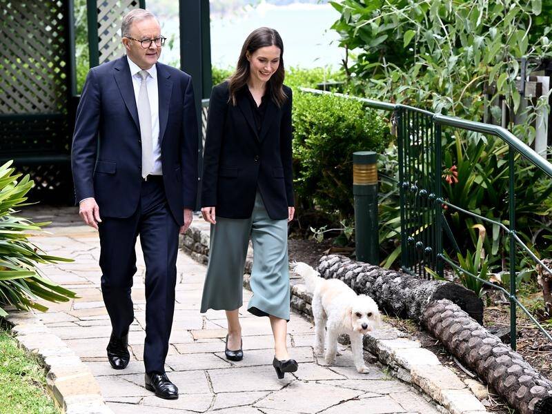 Prime Minister Anthony Albanese, with his dog Toto, with Prime Minister Sanna Marin of Finland. (Dan Himbrechts/AAP PHOTOS)