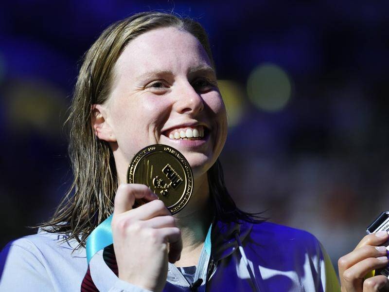 Lilly King holds her gold medal after winning the world 200m breaststroke title.