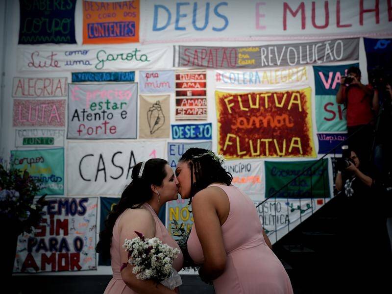 Dozens of gay couples have married in Brazil, over fears gay rights could be wound back.